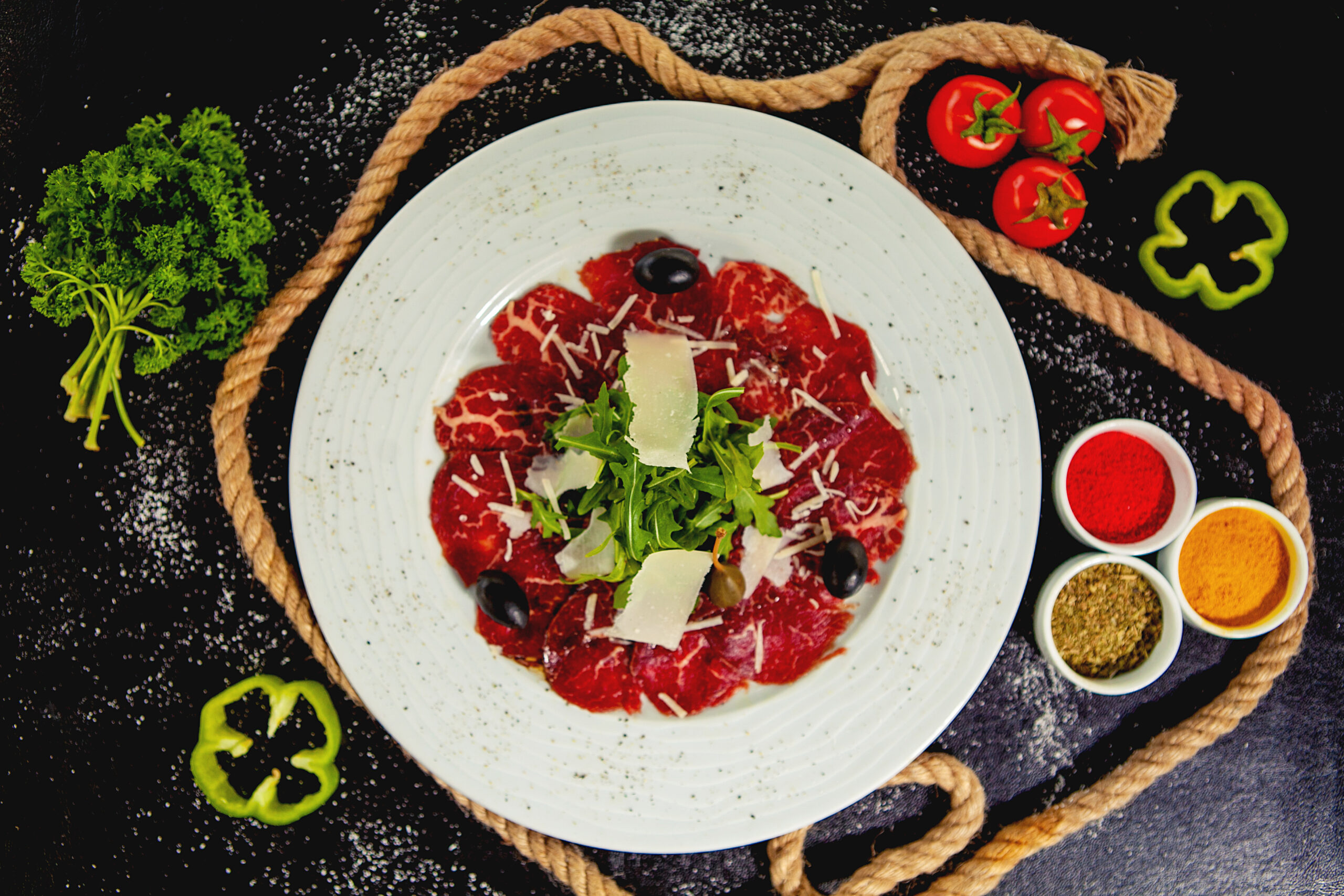 beef carpaccio with parmesan, arugula and olives